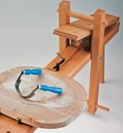 A chair seat clamped in a shaving horse