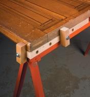 Holding a door in place on a sawhorse using two vertical stops attached with bench anchors and fasteners 