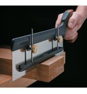 Depth stop mounted to saw, cutting through a block of wood