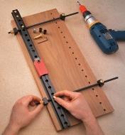 Clamping the rail onto a panel before drilling holes 