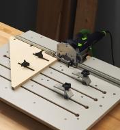 A Domino joiner mounted on a Veritas Domino joinery table, shown with two fences and two hold-downs 