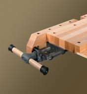 A Veritas quick-release sliding tail vise mounted at the end of a workbench