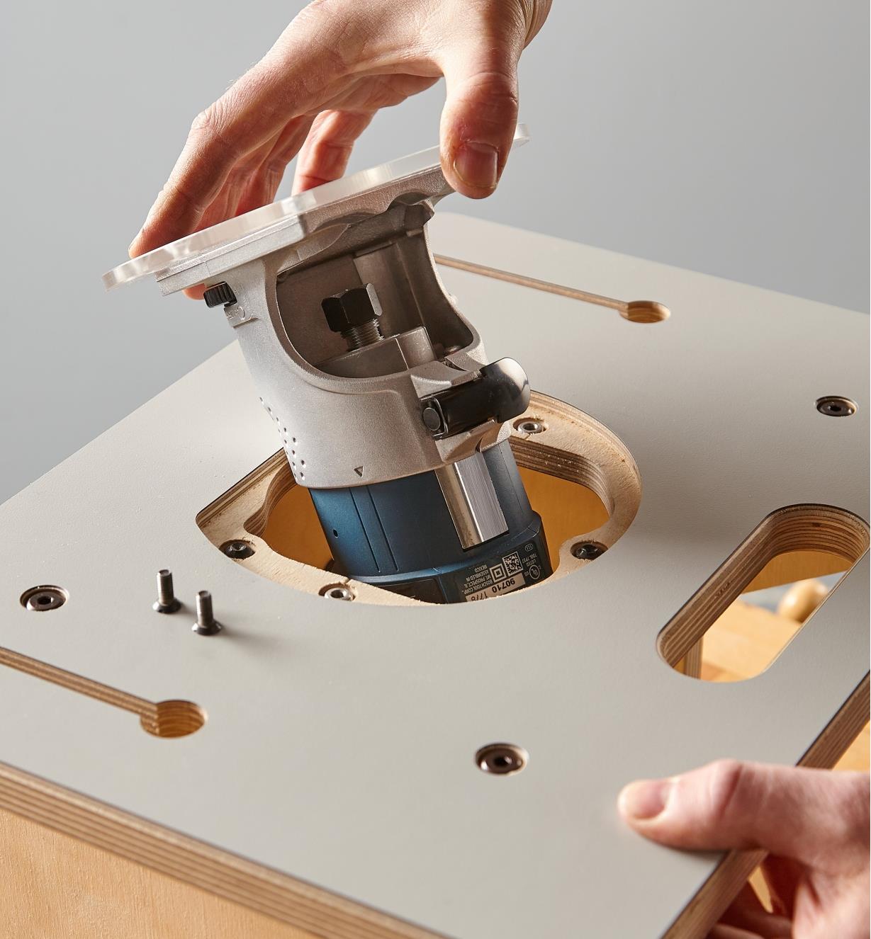Inserting the compact router and base plate into the Veritas table for compact routers