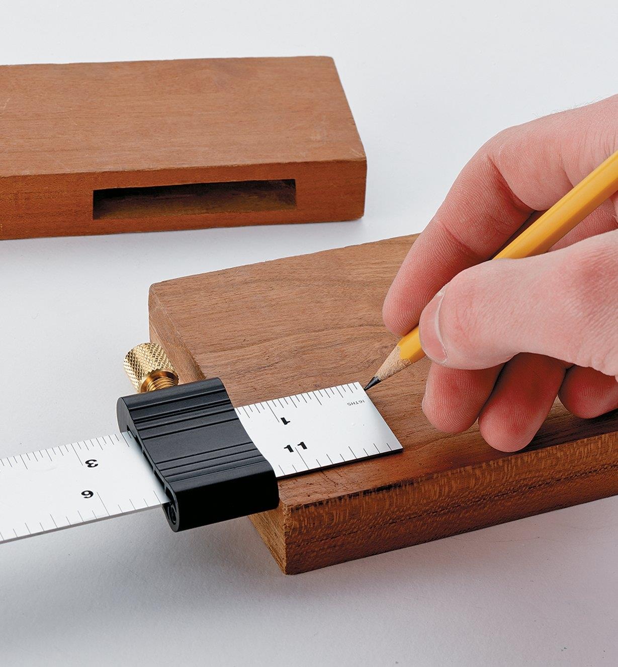 Using a ruler stop attached to a steel rule to mark out the depth of a mortise on a piece of wood