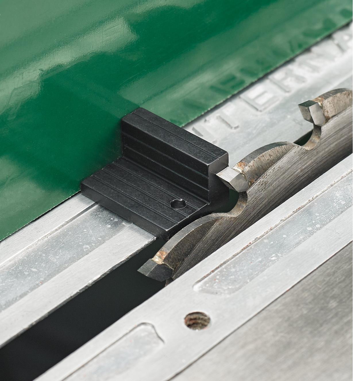Setting the distance between the blade and fence on a table saw using the layout block