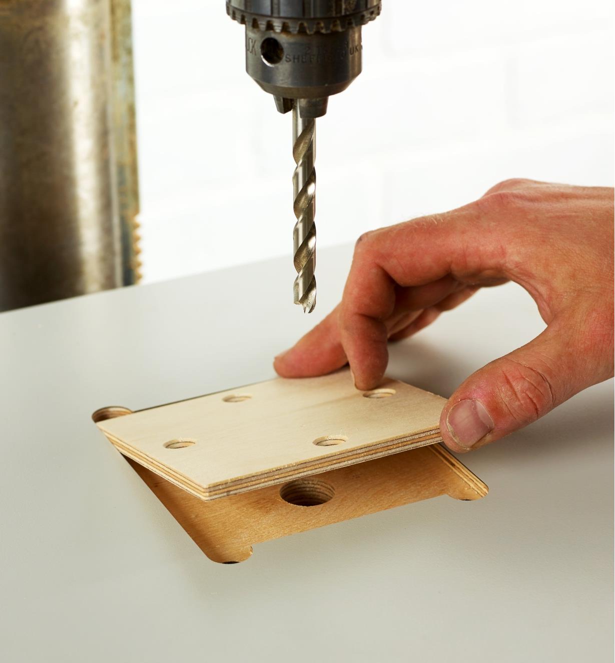 Setting the removable wooden insert into the table top to support through-drilling