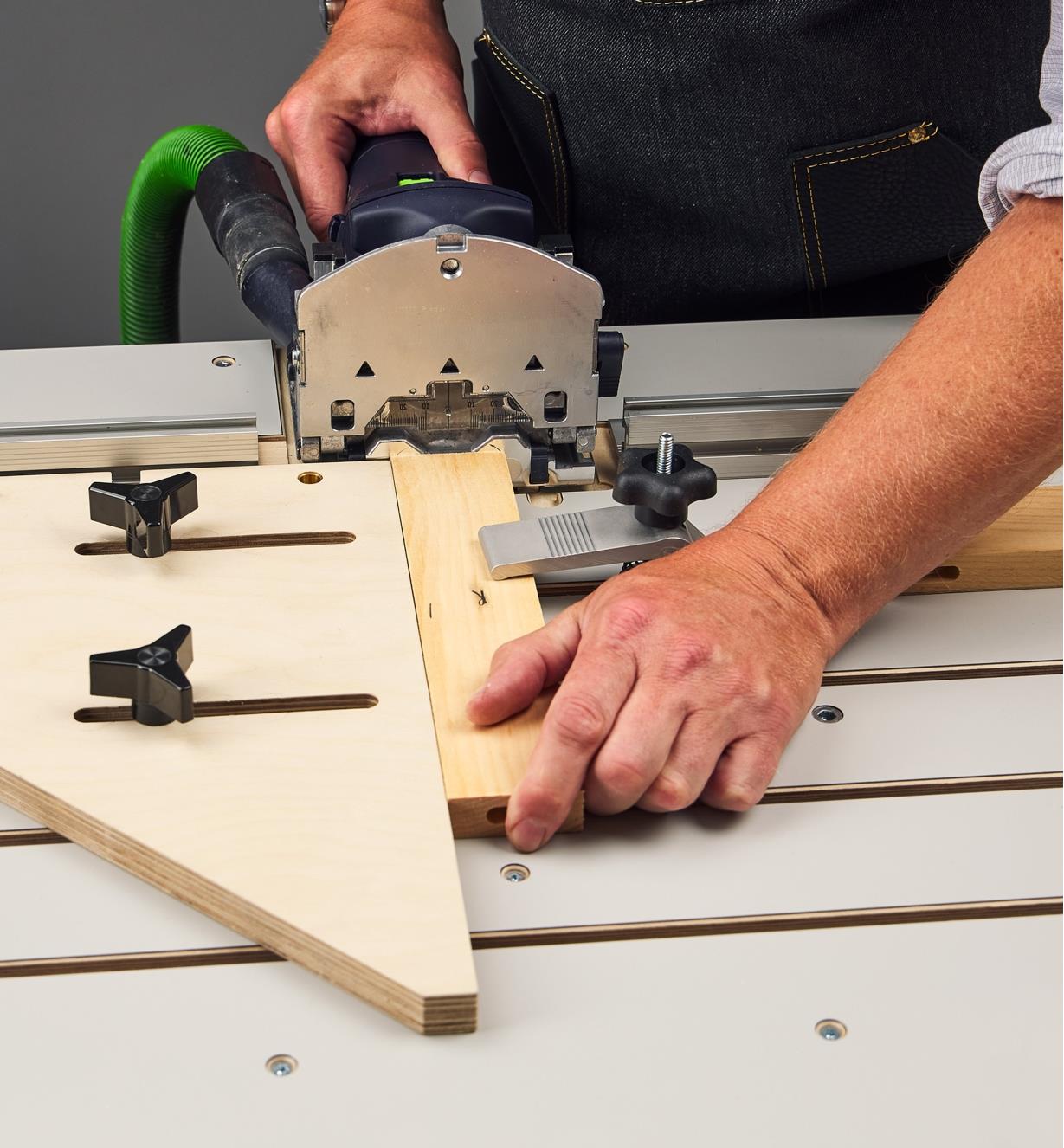 A Domino joiner used on a Veritas Domino joinery table to cut butt-joint mortises in end grain