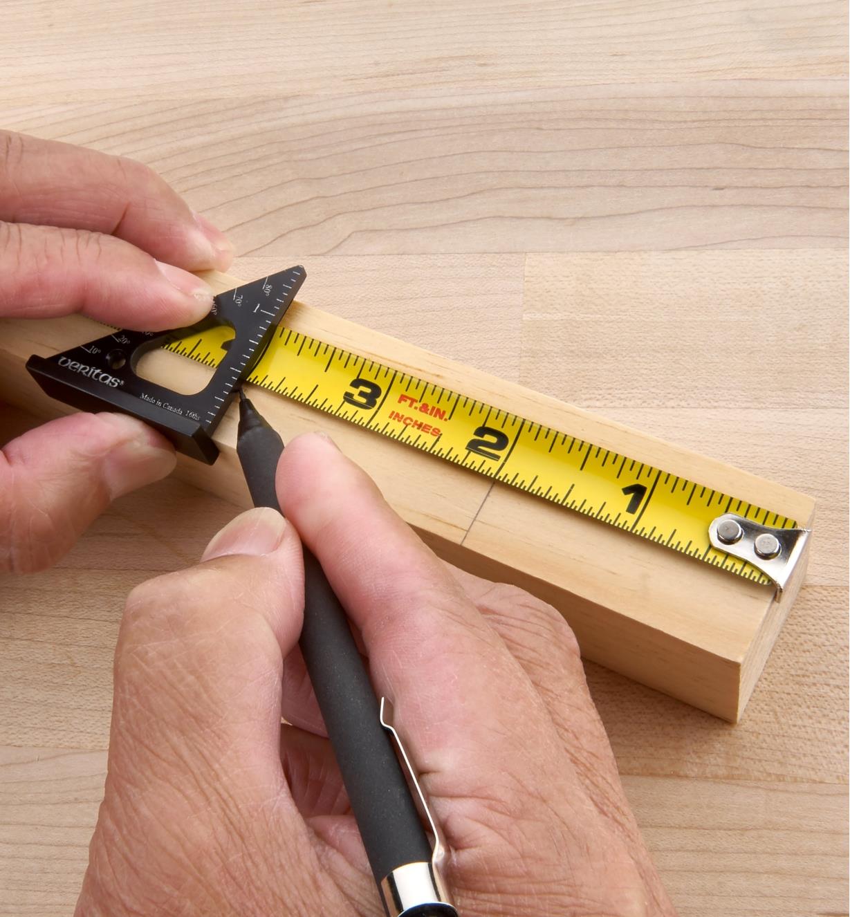 Using a Veritas 1 1/2"" Pocket Layout Square over a tape measure to strike a line on a workpiece