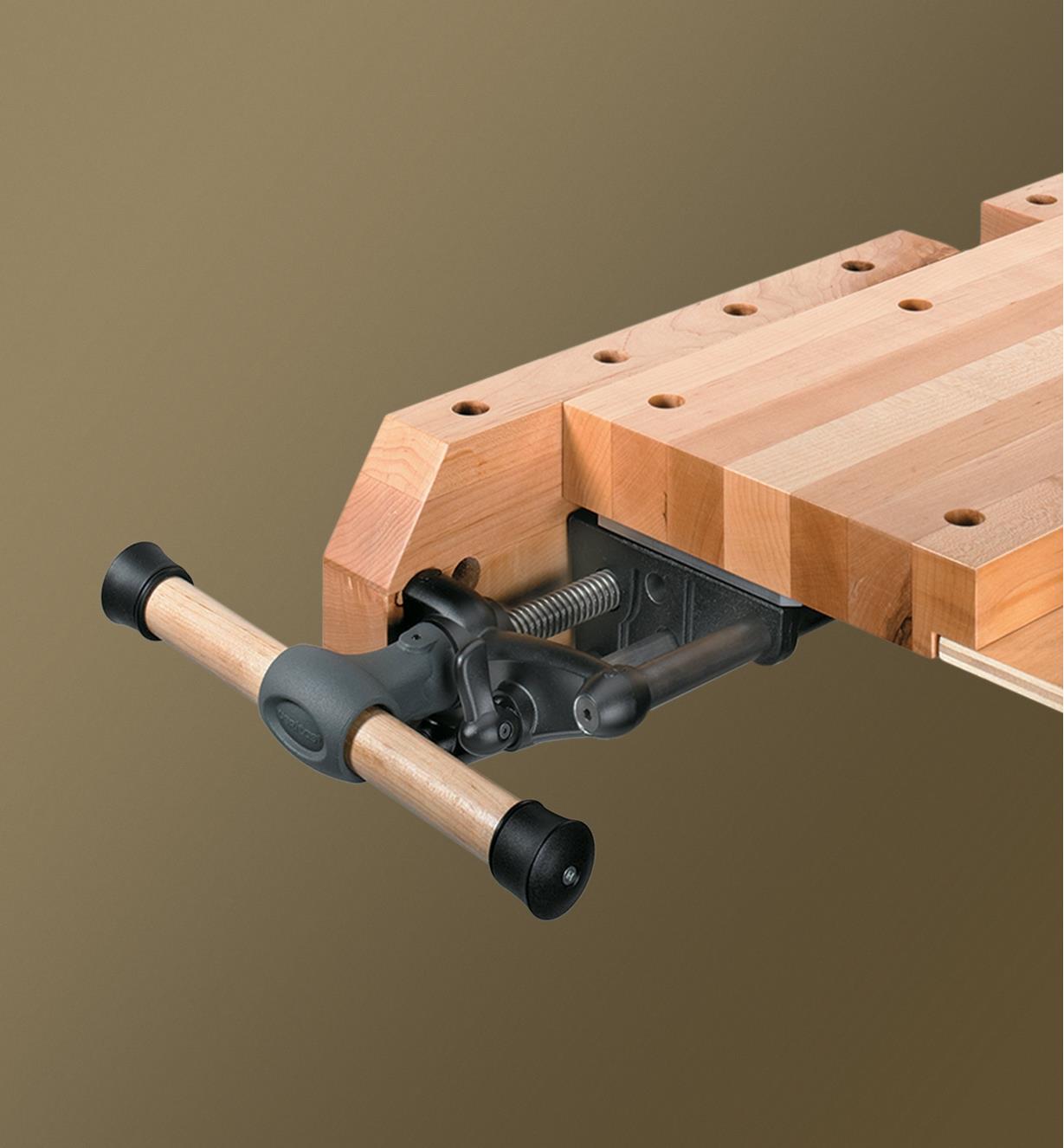 A Veritas quick-release sliding tail vise mounted at the end of a workbench